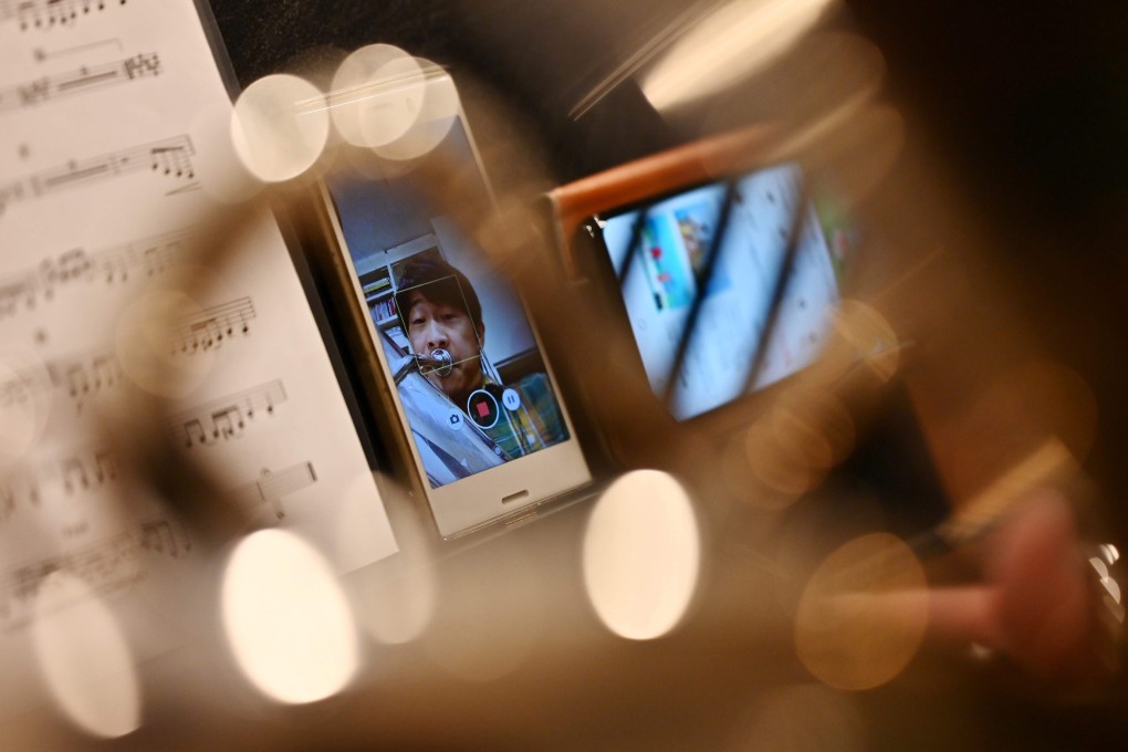 Kazuhiko Sato of the New Japan Philharmonic Orchestra records himself in his soundproof room at home in Tokyo. Photo: Charly Triballeau/AFP