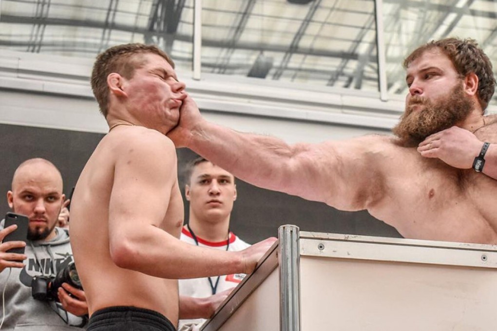 Vasiliy “Dumpling” Komotskiy slaps an opponent at the 2019 Siberian Power Show. Photo: Dmitry Kotov