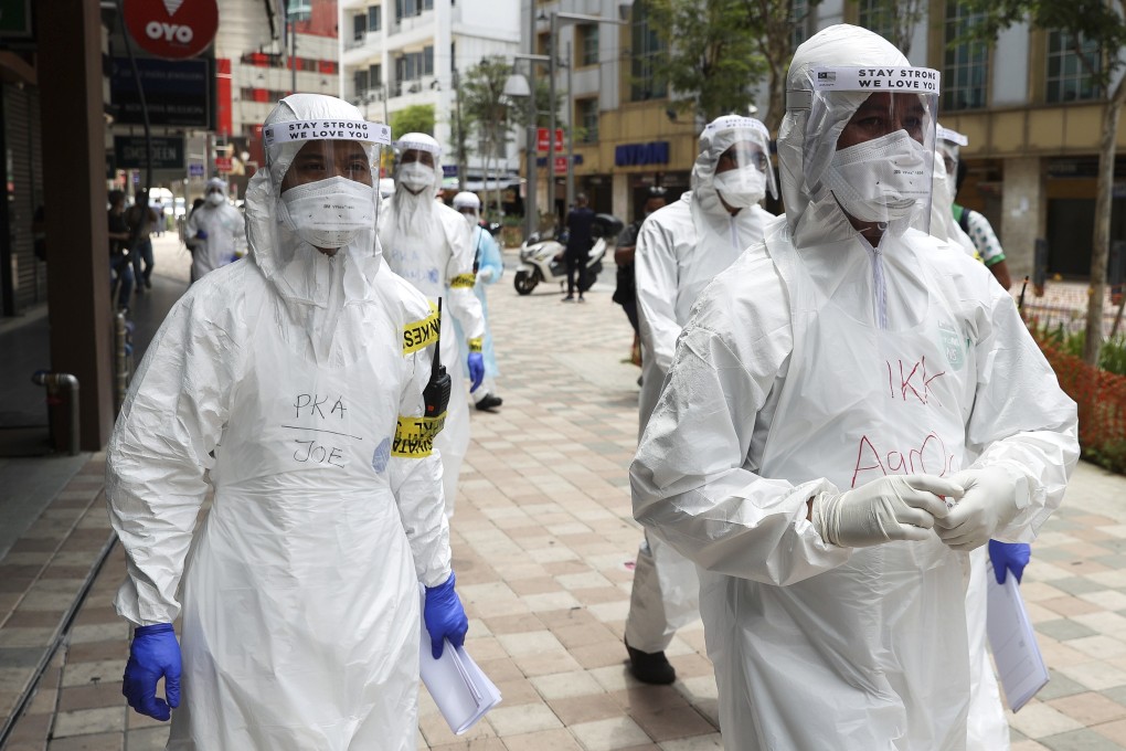 Officials from various Malaysian agencies conduct a screening in Kuala Lumpur. Effective national measures against Covid-19 are an indispensable foundation for a potent regional response to the pandemic. Photo: DPA