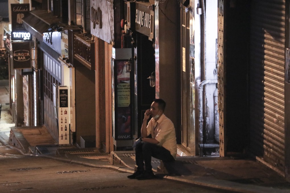 A man sits alone in the deserted nightlife district of Lan Kwai Fong in Hong Kong on April 2. Photo: Dickson Lee