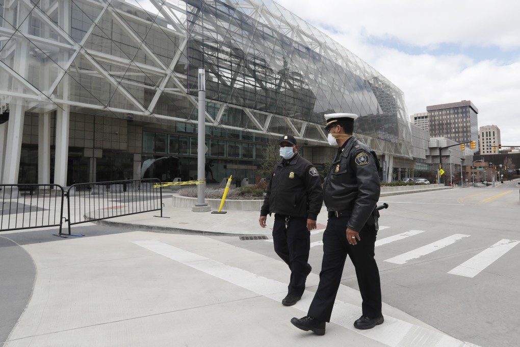 Police officers walk along deserted streets in Detroit, Michigan, United States on Friday. Photo: AP