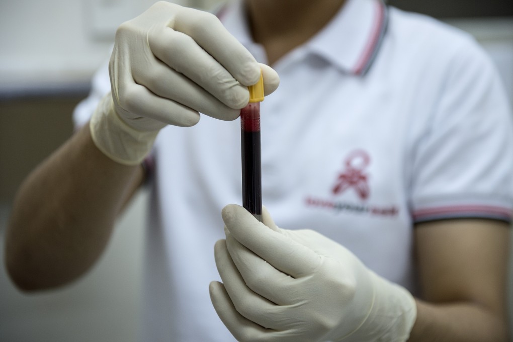 A nurse holds a vial of blood at a testing centre in Manila. Photo: AFP