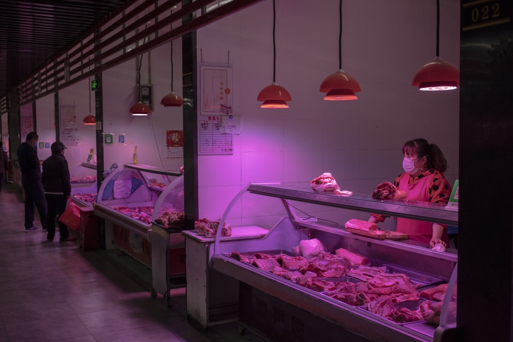 A vendor at a pork stall at a market in Beijing, China. Photo: EPA