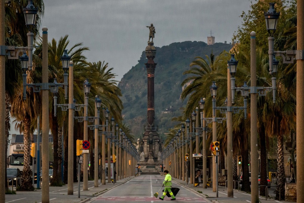 A Barcelona avenue is empty except for a cleaning worker during a nationwide lockdown to curb the spread of the coronavirus. Photo: DPA