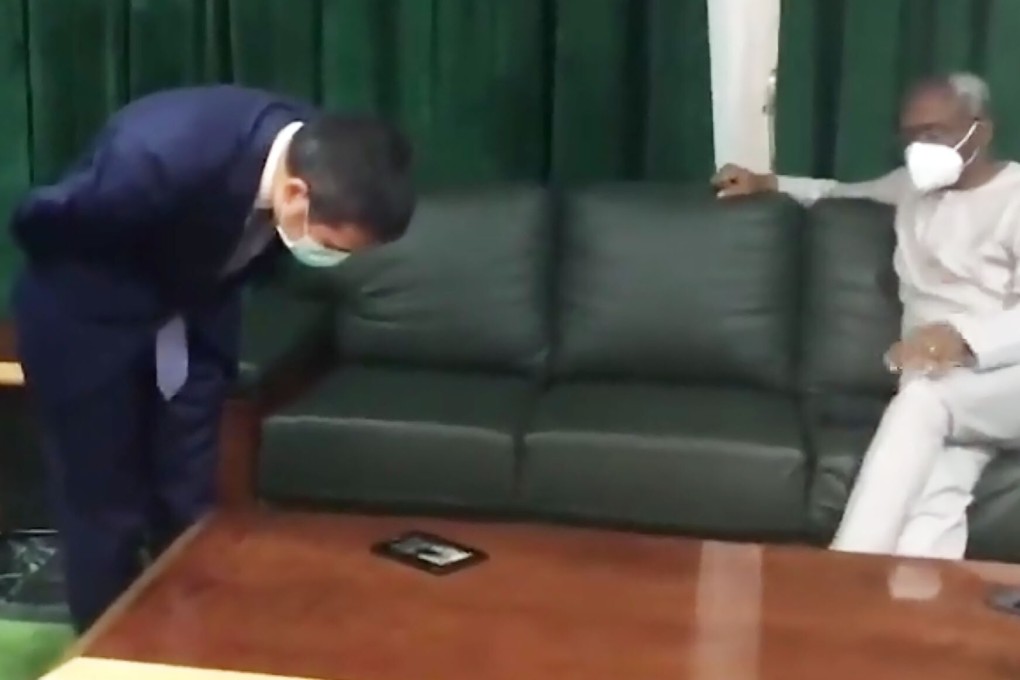 The Chinese ambassador to Nigeria Zhou Pingjian watches a video alleged to show improper behaviour by quarantine staff during a meeting with Femi Gbajabiamila, the speaker of Nigeria’s House of Representatives. Photo: Weibo