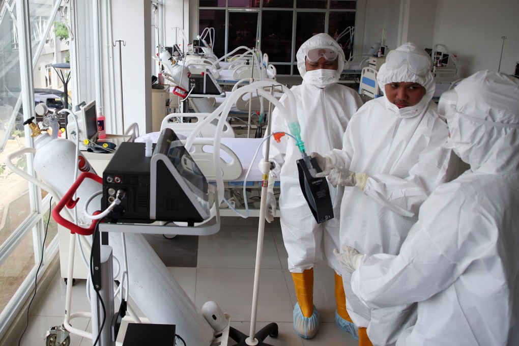 Health care workers prepare an intensive care unit room at a temporary hospital to house coronavirus patients in Jakarta. Indonesia recorded 316 new cases and another 26 deaths on Monday. Photo: EPA-EFE
