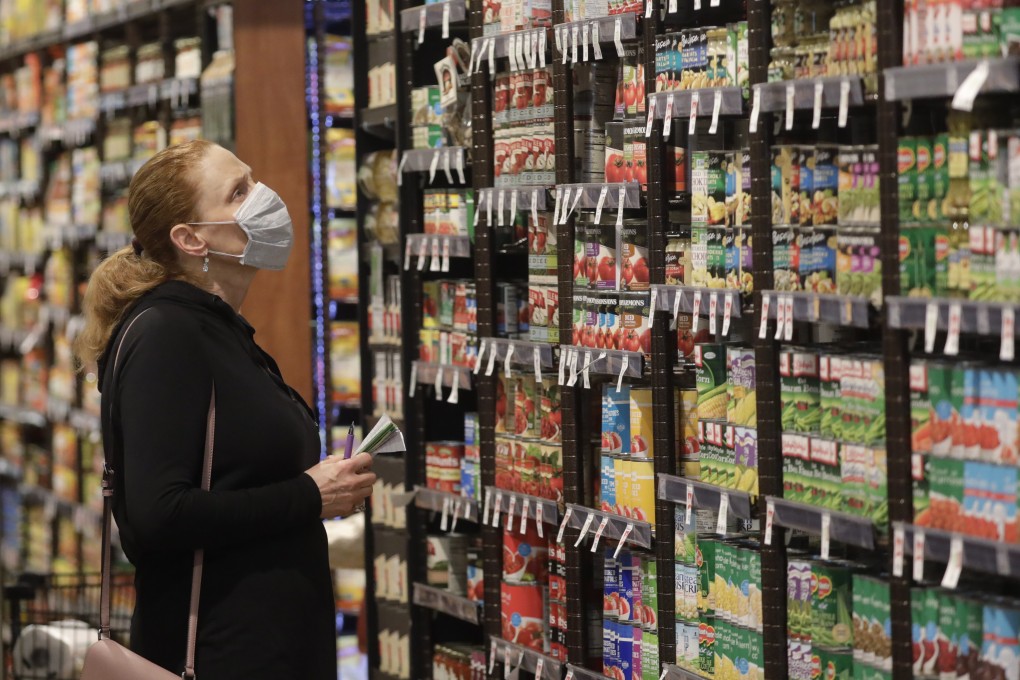 Shopper Erin Call wears a mask as she shops for groceries at Harmons grocery store Friday, April 3, 2020, in Salt Lake City. Photo: AP