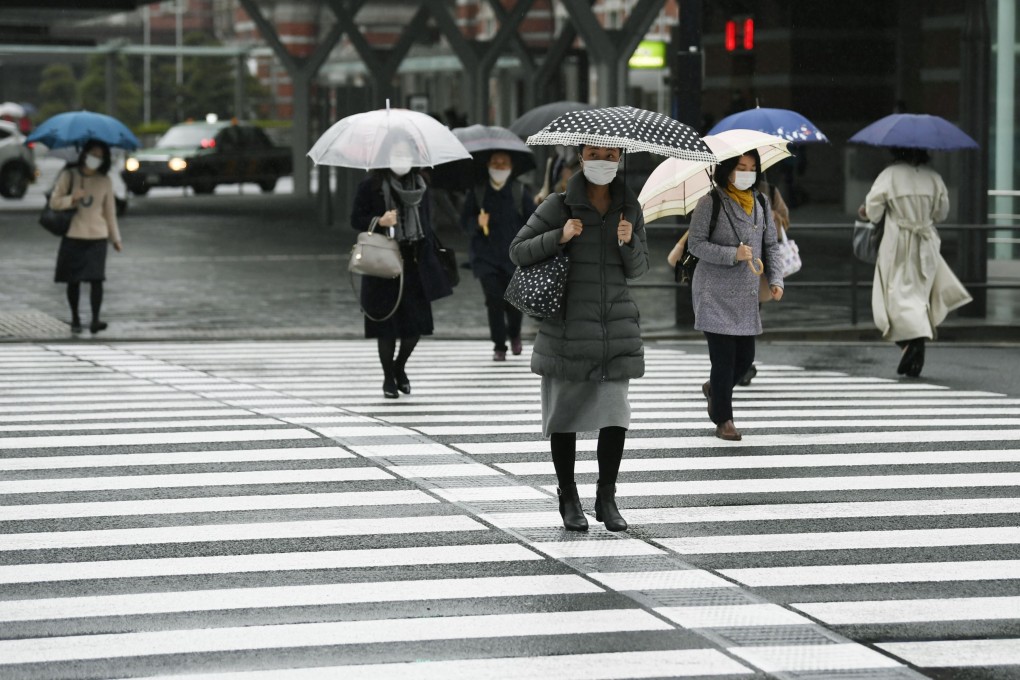 Masked commuters head to work near Tokyo Station on Monday, after the city and other parts of the country were placed under a state of emergency last week to halt the spread of coronavirus infections. Photo: Kyodo