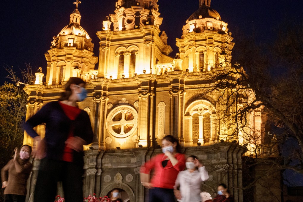 Women in front of St. Joseph's Catholic Church in Beijing on April 12, 2020. Photo: Reuters
