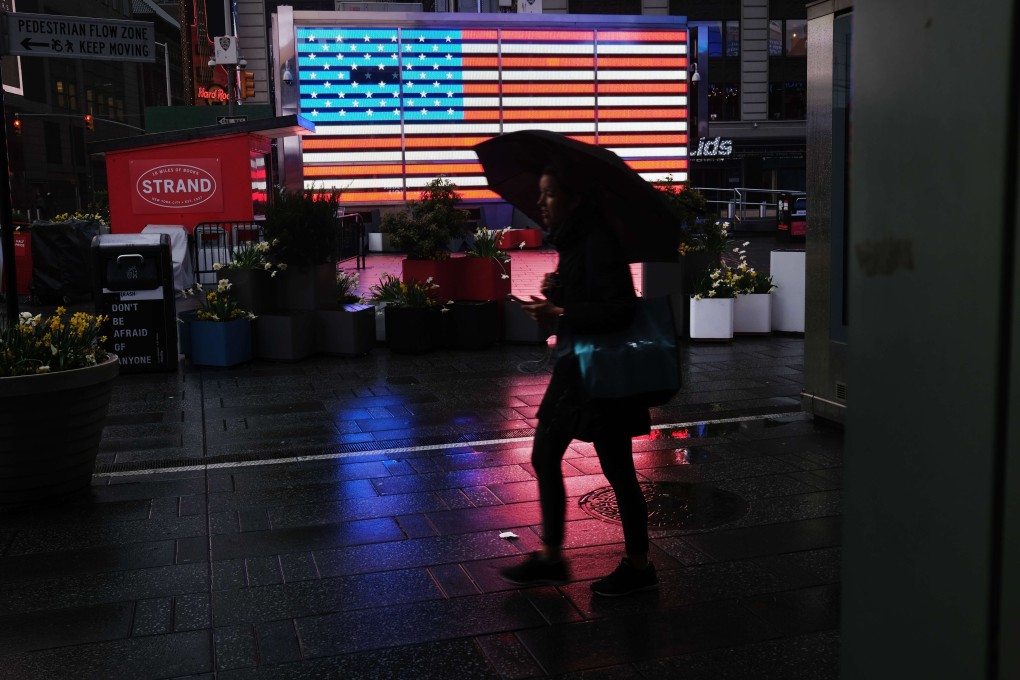 A pedestrian walks in a mostly desolate Times Square in New York on Monday. Photo: AFP