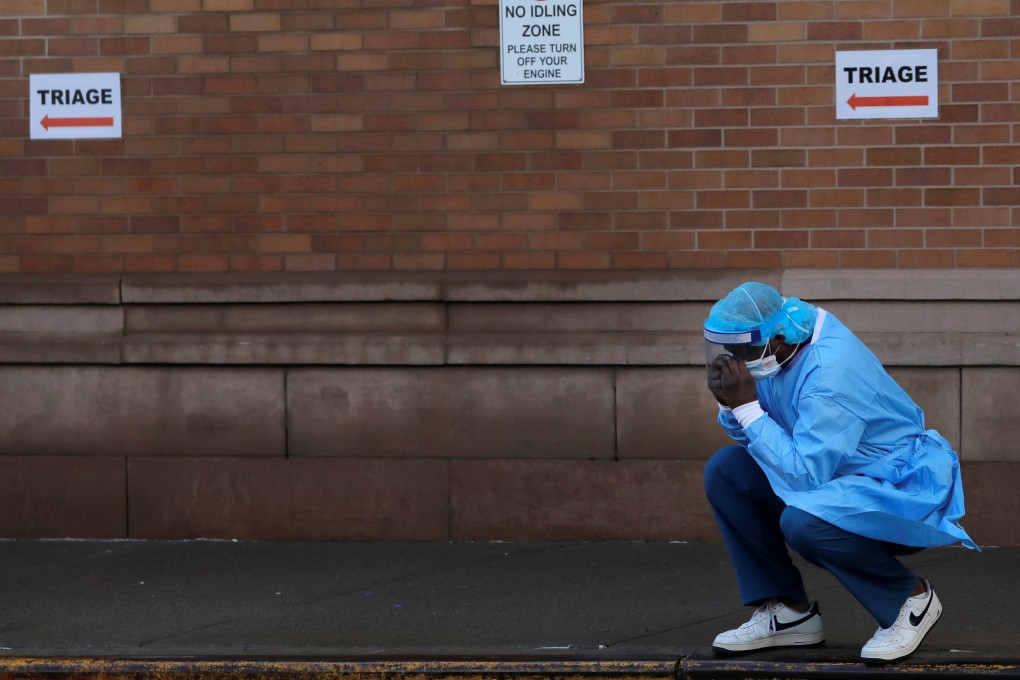 A healthcare worker takes a break outside the Maimonides Medical Centre in New York. Photo: Reuters