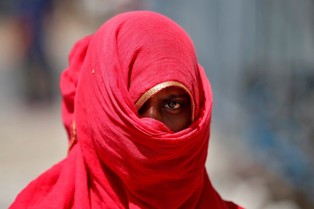 A woman waits to collect free grocery items during India’s nationwide lockdown. India’s National Commission for Women says domestic violence has been increasing since the lockdown started on March 25. Photo: Reuters