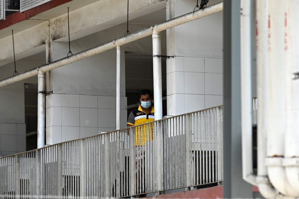 A migrant worker looks out from a window of his Singapore dormitory. Photo: AFP