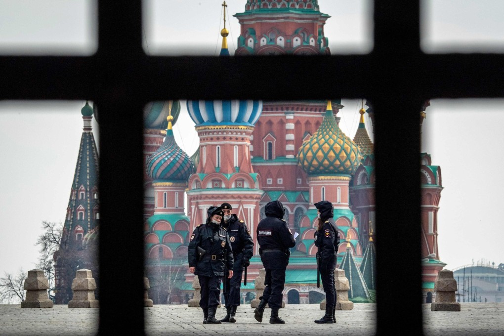 Police patrol the deserted Red Square in downtown Moscow. Photo: AFP