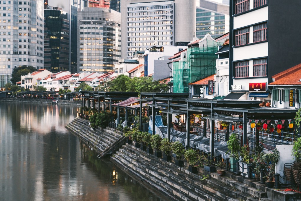 Terraces sit empty in riverside restaurants and bars at Boat Quay in Singapore. Governments in Singapore and elsewhere are delivering stimulus packages to support economies heading for recession. Photo: Bloomberg