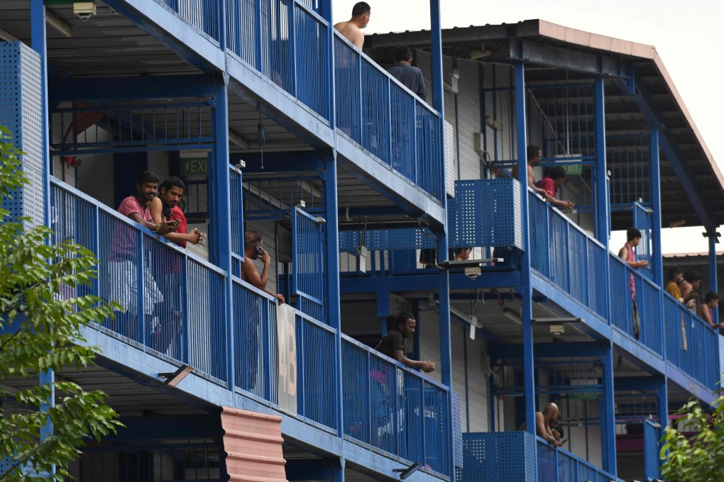 Foreign workers are seen on the corridors of the S11 dormitory in Punggol, Singapore, which became a hotspot for the spread of coronavirus infections in the city state. Photo: AFP