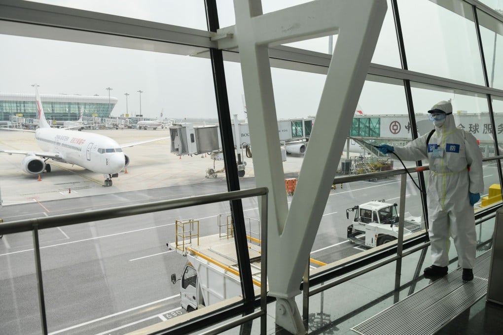 A firefighter disinfects Wuhan’s international airport building. Last month, the volume of passengers in China slumped 71.7 per cent year while the volume of cargo declined 23.4 per cent. Photo: Xinhua