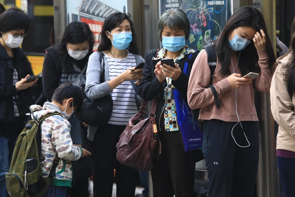 Commuters in masks queue for public transport in Hong Kong. Photo: May Tse