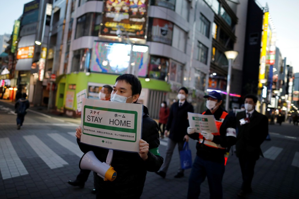 Tokyo metropolitan government staff urge people to stay home after the government imposed a state of emergency for the Japanese capital and some prefectures following the Covid-19. Photo: Reuters