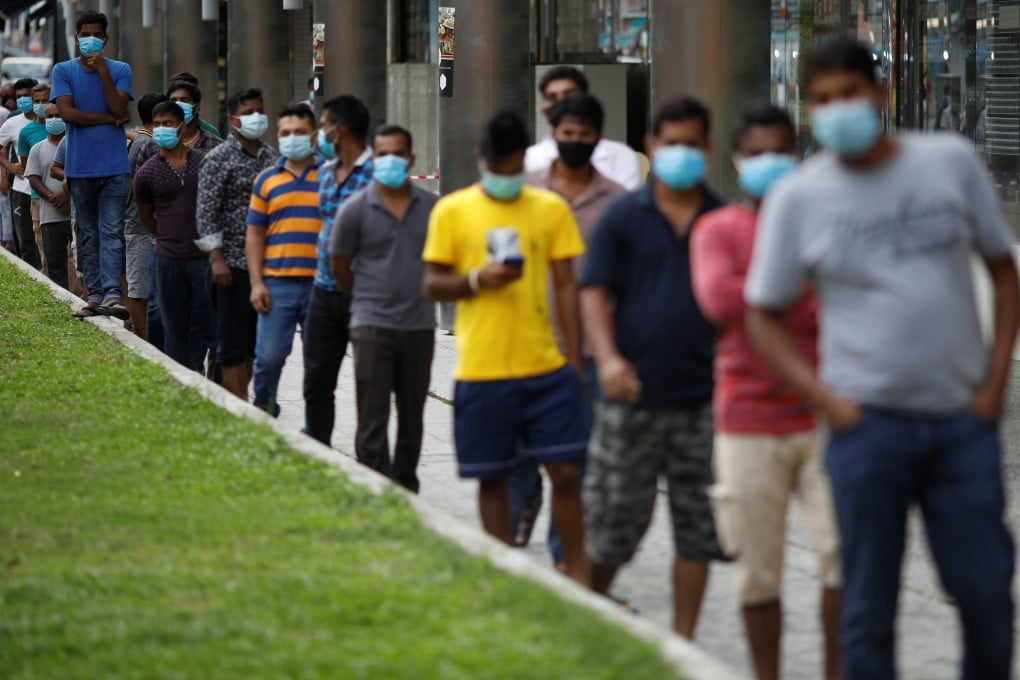 Migrant workers wait for meals in Little India district in Singapore. The outbreak of Covid-19 in foreign worker dormitories was predicted and is a mistake Singapore must learn from. Photo: Reuters