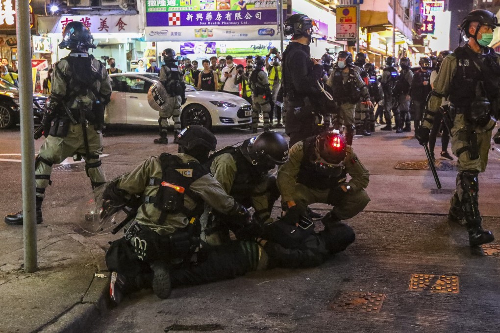 Riot police detain an anti-government protester in Mong Kok on February 29. Photo: Felix Wong