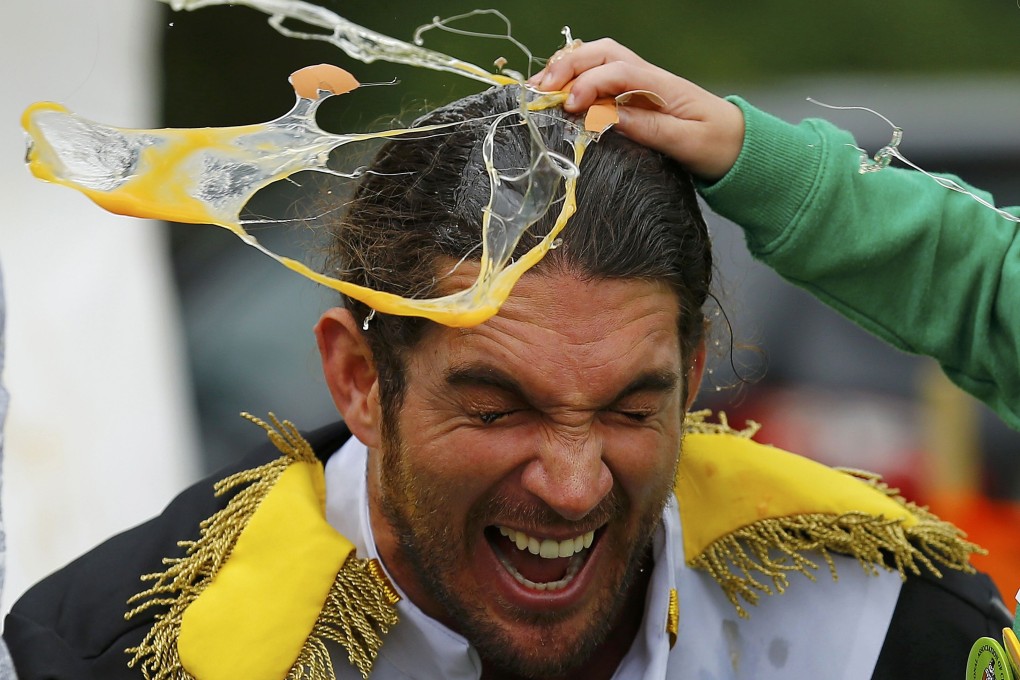 A man has an egg smashed on his head during the 2015 World Egg Throwing Championships. Photo: Reuters