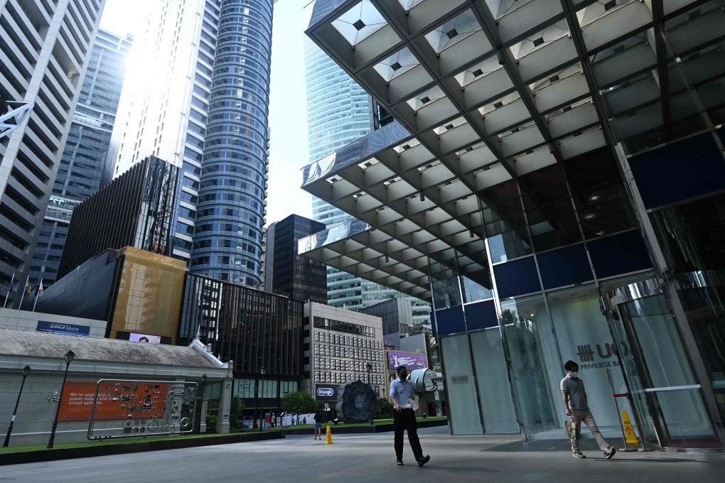 People wear face masks in Singapore’s financial district as a preventive measure against the spread of Covid-19. Photo: AFP