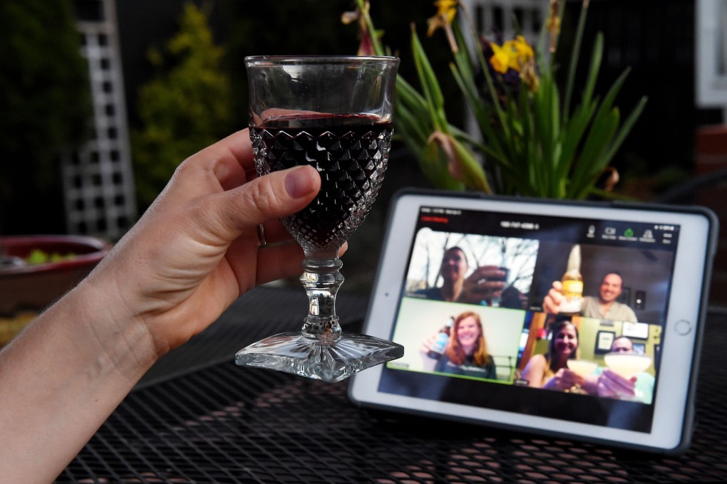 A woman lifts her glass to share a toast with friends online via the Houseparty app during a virtual happy hour on April 8 in Arlington, Virginia. Photo: AFP