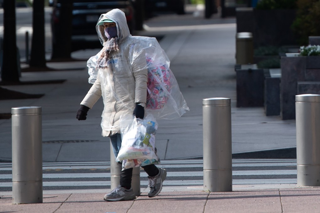 A person wearing a mask walks outside the IMF headquarters in Washington on Wednesday. Photo: AFP