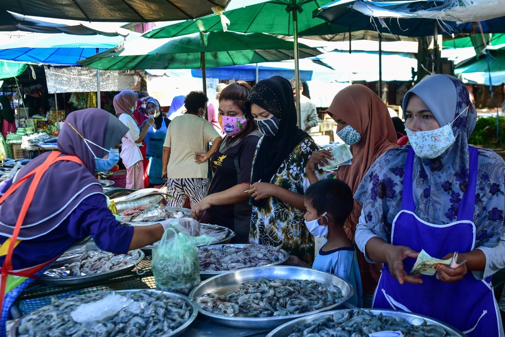 Women buy seafood at a market in Thailand’s southern province of Narathiwat. Photo: AFP