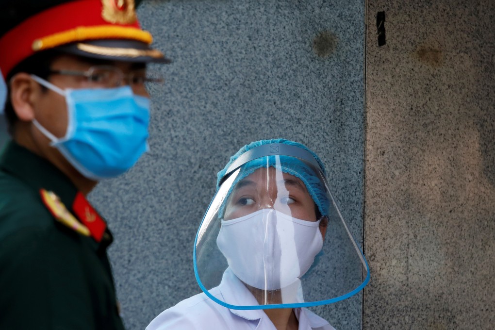 A health worker next to a soldier in Hanoi, Vietnam April 14. Photo: Reuters