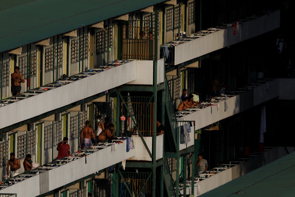 Migrant workers outside their dormitory rooms at Cochrane Lodge II in Singapore. Photo: Reuters