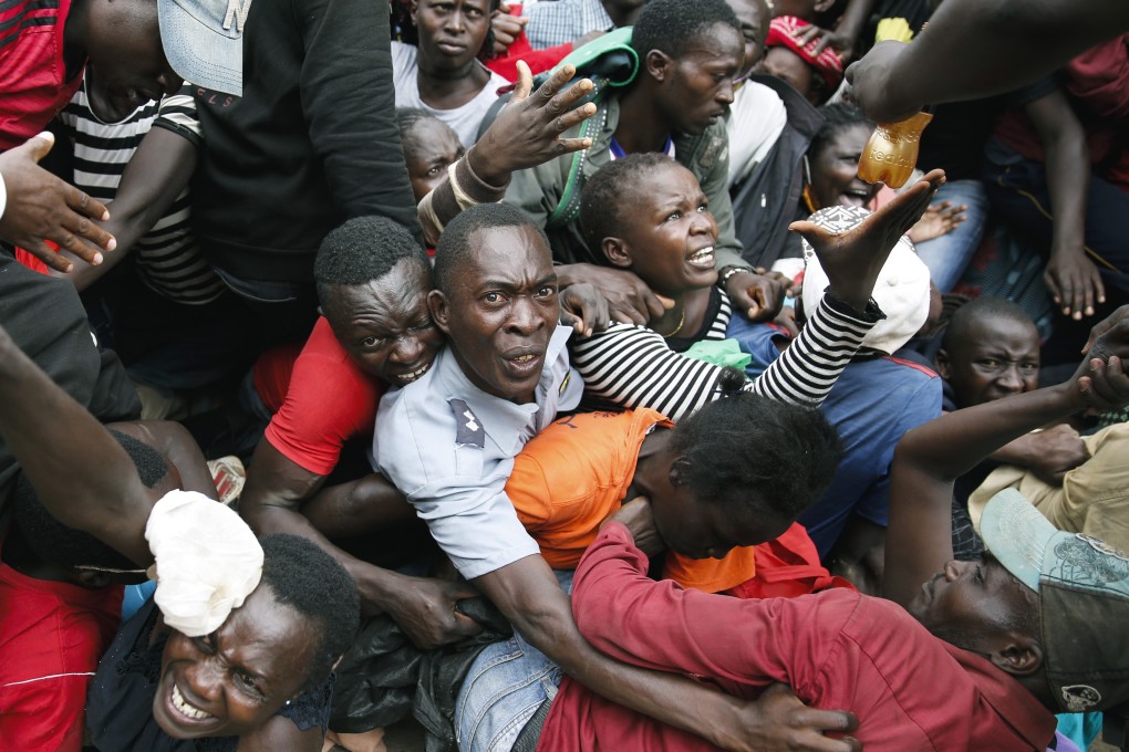 Scores of people in Kenya’s Kibera slum were injured when tear gas was fired on desperate residents rushing for a food donation. Photo: AP