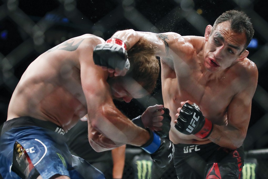 Tony Ferguson punches Donald Cerrone during their lightweight bout at UFC 238. Photo: AP