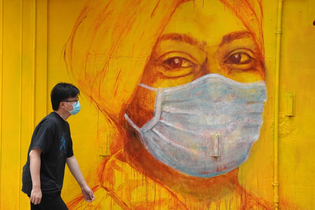A man walks by an advertisement in Central, Hong Kong, during the coronavirus pandemic. Photo: Handout