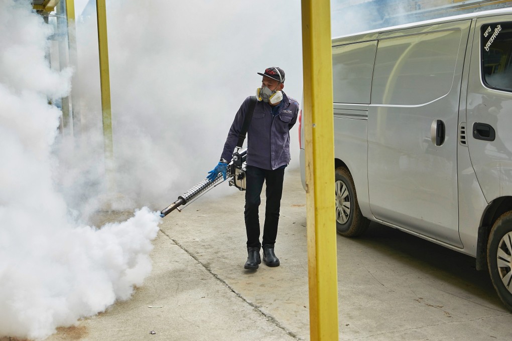 A worker fumigates the premises around S11 Punggol dormitory in Singapore on April 7, 2020. Photo: Handout via Reuters