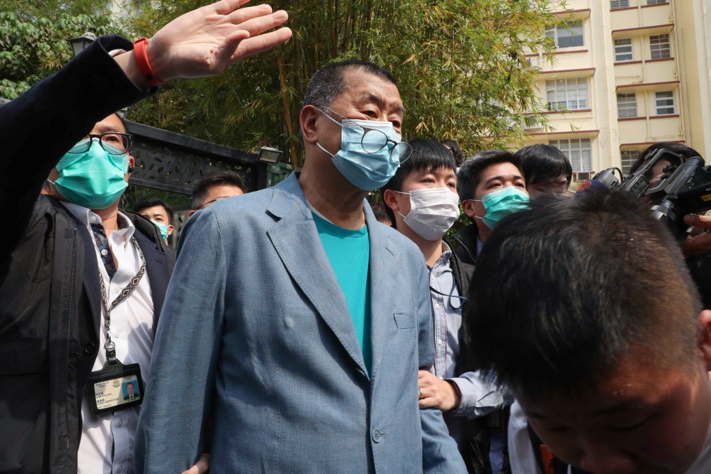 Apple Daily founder Jimmy Lai being escorted out of his home by officers. Photo: Edmond So