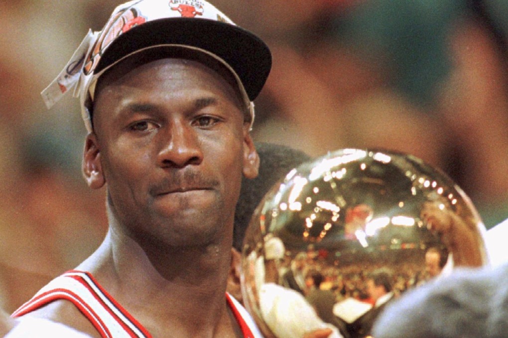 Chicago Bulls star Michael Jordan stands with the 1996 NBA Championship Trophy, his side’s fourth title. Photo: Reuters
