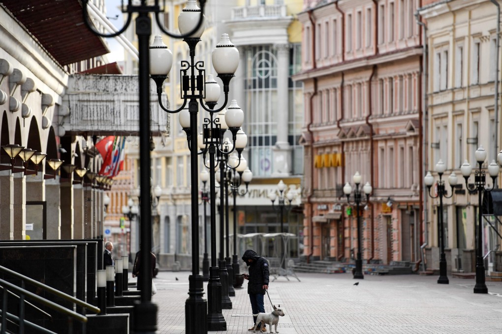 A man in Moscow walks his dog during the strict Covid-19 lockdown. People – particularly Chinese citizens – coming into China from Russia are threatening containment efforts. Photo: AFP