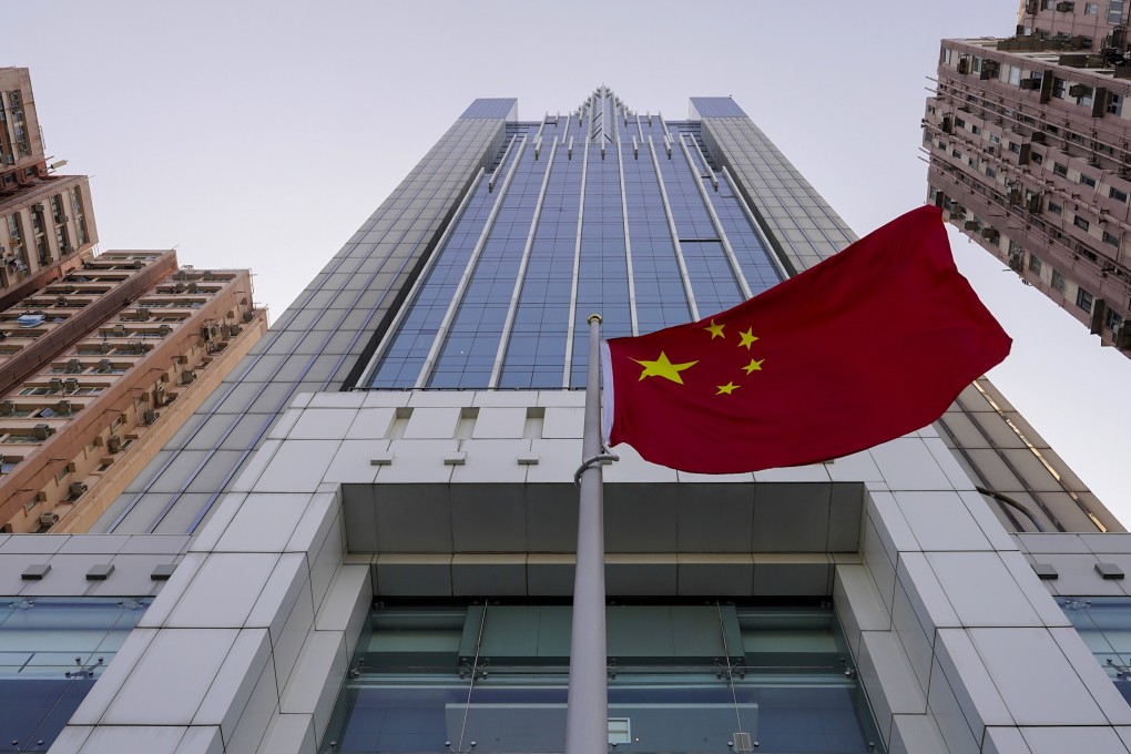 The national flag flutters in the breeze outside China’s liaison office building in Hong Kong. Photo: AP