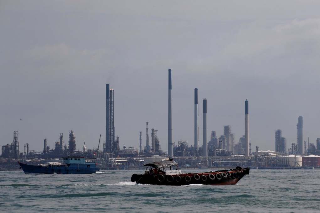 Boats sail past Pulau Bukom oil refinery along the southern coast of Singapore. The city state which has built itself into one of the world’s most important oil markets and the biggest ship fuelling hub. Photo: Reuters