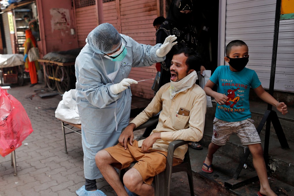 A doctor collects a swab sample from a man in India’s Mumbai. Photo: Reuters