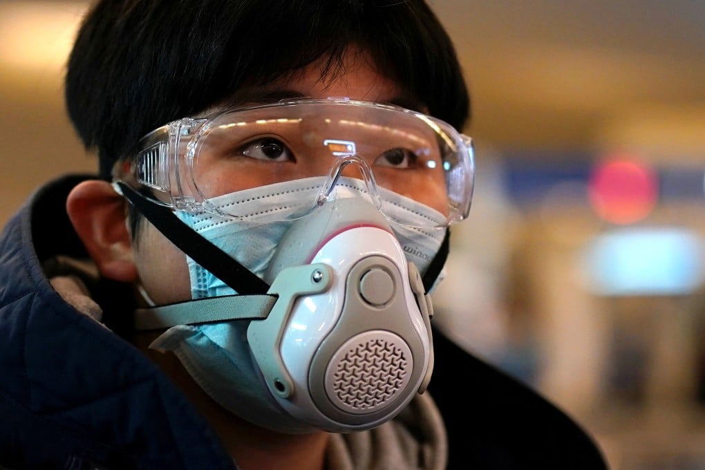 A passenger wearing a protective mask arrives at a railway station in Wuhan on the first day inbound train services resumed following the coronavirus outbreak. Photo: Reuters
