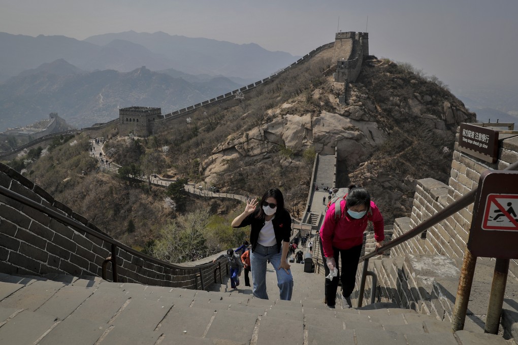 Women wearing protective face masks to prevent the spread of the new coronavirus walk on a stretch of the Badaling Great Wall of China in Beijing, Tuesday, April 14, 2020. Photo: AP