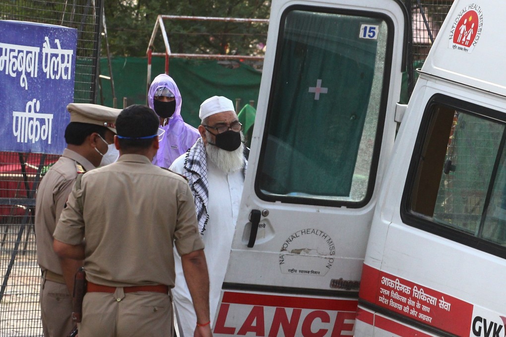 A man boards an ambulance at a quarantine centre. Photo: AFP