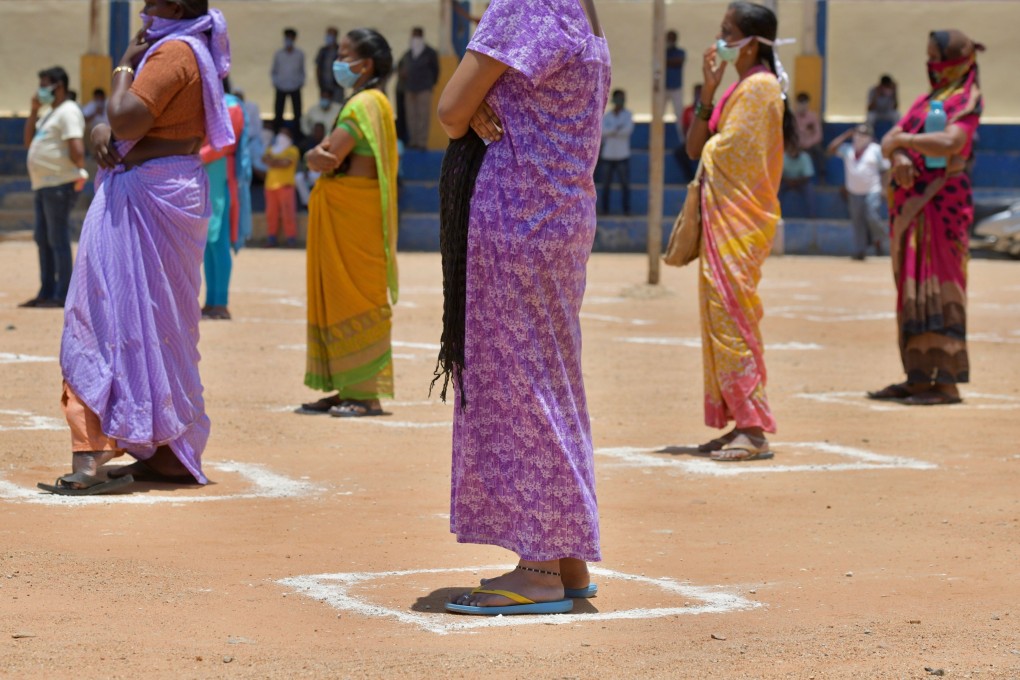 People in need wait for their turn to collect free ration and groceries distributed by the Karnataka State Congress during the government-imposed nationwide lockdown against the spread of coronavirus, in Bangalore. Photo: AFP
