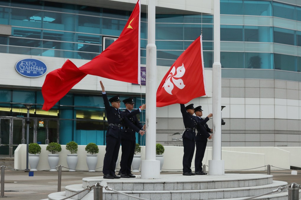 Hong Kong police officers perform a flag-raising ceremony at the Golden Bauhinia Square in Wan Chai. Photo: Nora Tam