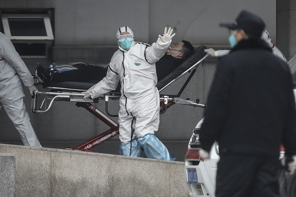Medical staff transfer patients to Jin Yintan hospital in January 2020 in Wuhan, China. Photo: Getty