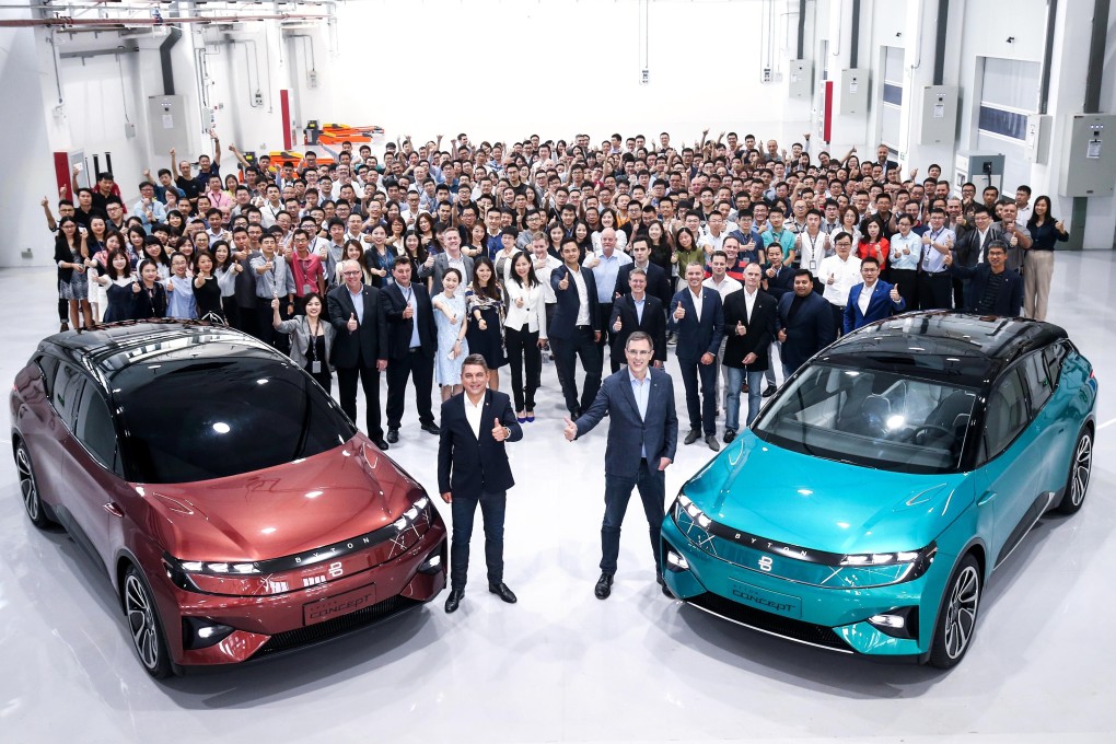 Byton founder and chief executive Daniel Kirchert, on the right foreground, poses with the company’s staff and a pair of electric vehicles at its headquarters in Nanjing, capital of eastern coastal Jiangsu province. Photo: Handout