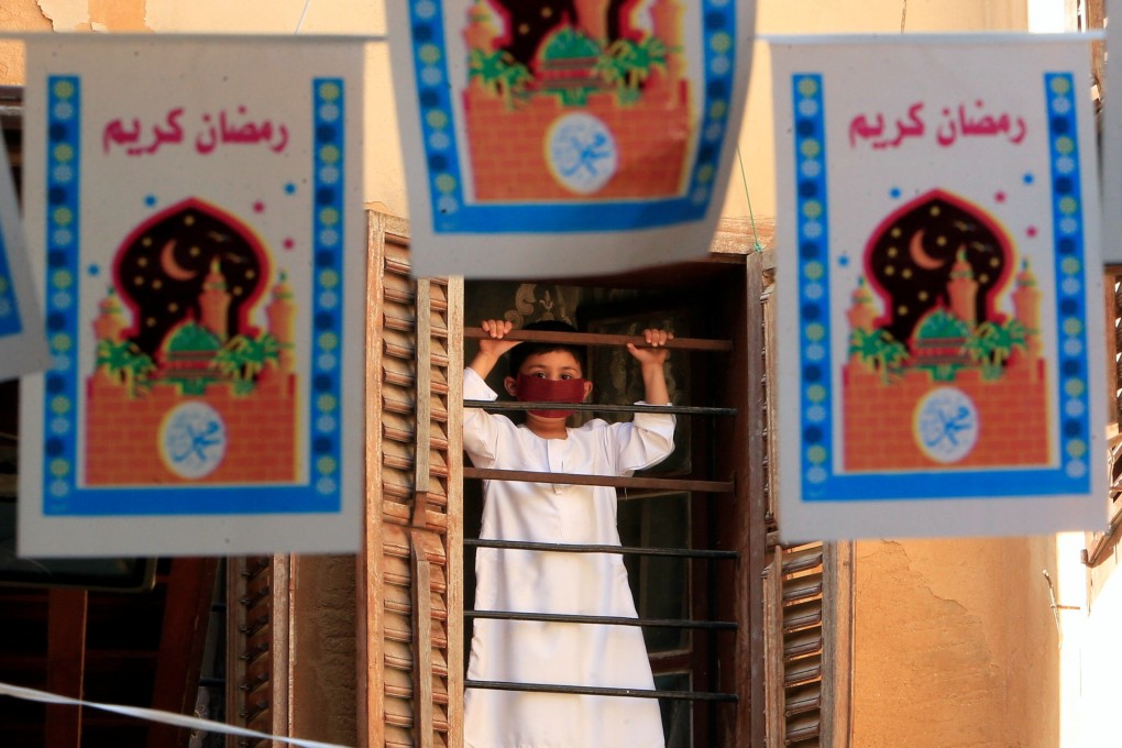 A boy wears a protective mask as he looks through a window in Sidon, Lebanon. Photo: Reuters